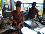 Samantha Brown obtained a small loan to expand her and her husband's business producing and selling tin products. Photo Credit: Andrea Rohlehr-McAdam