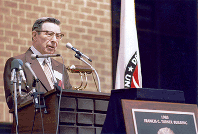 Frank Turner speaks at the dedication of the Francis C. Turner Building at the Turner-Fairbank Highway Research Center in McLean, VA, on May 5, 1983. Turner was honored as "a man who thrived on change, believed in innovation based on facts  gathered through research, and played a significant role in implementing research results in the United States and the world."