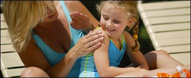 Photo: A mother applying sunscreen on her daughter