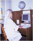 Nun sitting at a computer