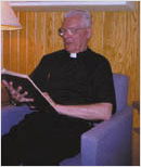 Priest sitting and reading a book