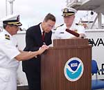 NOAA administrator signs documents authorizing the transfer of of a former Navy ship to NOAA to be used as an ocean exploration vessel.