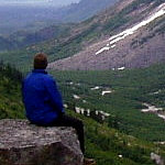 Resting backpacker enjoys wilderness solitude.