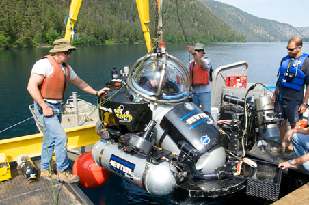 Engineers from Nuytco lower PLRP Co-PI Greg Slater into the waters of Pavilion Lake in one of the DeepWorker mini-subs. Credit: Henry Bortman