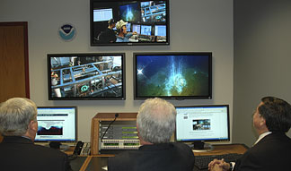 Live images and data are displayed on large screens at the command centers