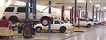 photo: white cars in maintenance bays