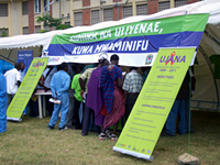 Young people gather at the UJANA booth to learn more information about the project.  The banner above reads ‘Be satisfied with the one you have, be faithful,’ both abstinence and faithfulness messages were promoted during the concert.