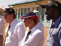 Dr. Hill, Ambassador Dybul and YOHO Director Vuyi Otukile watch the YOHO soccer game.