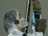 engineer inspects scoop on robotic arm of Phoenix
