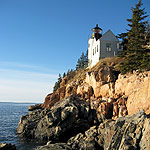 Lighthouse perched on rocky cliff