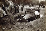 This March 1938 photo depicts a Pasadena resident digging his car out of mudslide debris