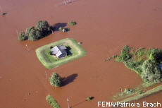 Photograph of a house surrounded by flood water