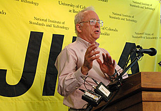 Nobel Laureate John (Jan) L. Hall describes his research to reporters at a news conference on Oct. 4.
