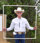 Clint Rollins, NRCS rangeland management specialist, Amarillo, showed landowners how to use the forage inventory clipping frame to determine pounds of available forage on their own land (NRCS photo -- click to enalrge)