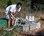 A geochemist in the field uses specialized equipment to conduct a groundwater test