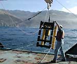 A researcher prepares to launch a laser line scan integrated with a tow body
