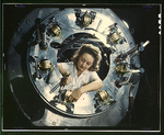 Woman working on part of the cowling for one of the motors for a B-25 bomber