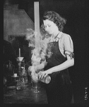 A laboratory assistant at a southern tin smelter performs delicate analytical operations that determine the amounts of pure metal remaining in slags from the furnaces
