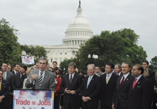 Gutierrez, surrounded by officials with U.S. Capitol in background. Click for larger image.