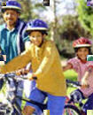 Family riding bicycles while wearing helmets