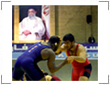 Photo of U.S. wrestler Mo Lawal grappling with Iranian wrestler Jafar Daliri.