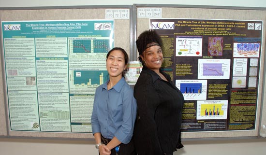 Displaying their work at Summer Research Poster Day are Christine Lin (l) and Nadelle Hamby.