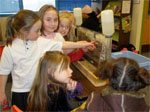 Brownies learn about groundwater conservation from a demonstration of the ground water flow model (NRCS photo by Karin Sonnen)