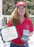 Laura Davis holds the Commander's Award for Civilian Service certificate, medals, ribbon and lapel pin