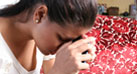 Holding her head in her hands a young female is thinking about her HIV positive test results