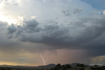 Lightning strikes at sunset with heavy clouds