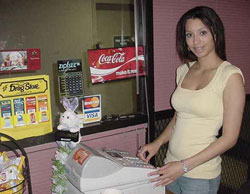 Young worker at cash register.