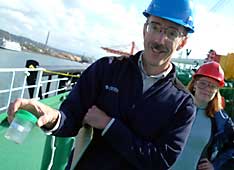 Russell Herwig holds a ballast water sample.