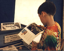 student examining contents of the "Zebra Mussel Mania Traveling Trunk"