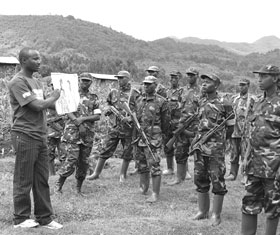 An educator shows pictures and talks about HIV
prevention with the soldiers of Rwanda’s 63rd Battalion.