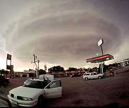 researchers in mobile mesonet evaluate a distant supercell and discuss storm intercept strategy