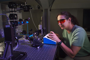 NIST physical scientist Joy Dunkers positions a polymer scaffold for imaging.
