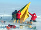 Photo of researchers setting up an Antarctic field camp.