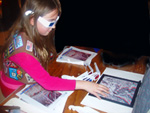 a Girl Scout reaches out to “touch” a mountain she sees while viewing a three dimensional landscape anaglyph with 3-D glasses