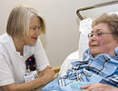 A nurse discusses with an elderly patient, Finland