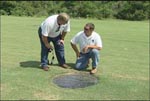 Three Rivers RC&D environmental specialist Travis Davis (left) and RC&D coordinator John Harper inspect a skylight on an arched culvert