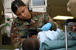 U.S. National Guard Senior Airman Belitza Hernandez, attached to the post anesthesia care unit aboard Military Sealift Command hospital ship USNS Comfort (T-AH 20), helps a recovering patient after surgery. 