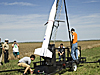 Johnathan McClure stands on a platform beside the rocket as the team prepares for launch