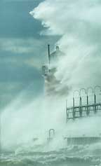 Storm-driven high waves pound the shoreline and damage property.