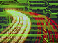 A graphic depiction of a computer circuit board with light streaks across it.