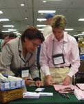 Maggie Irrizary and Laura Brandt sign up for their free USGS publications cd.