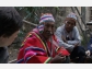 Photo shows indigenous Bolivian men being interviewed by linguists.