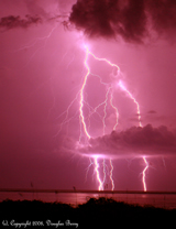 lightning in pink night sky with clouds