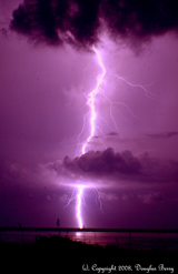 lightning in purple night sky with clouds