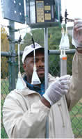 USGS scientist performing a routine calibration of an instrument used to collect air samples to be analyzed for volatile organic compounds