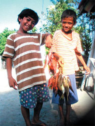 Photo of two boys holding fish.  Photo: USAID/Cleto L. Nanola, Jr.  Click here to read more about USAID in the Philippines.